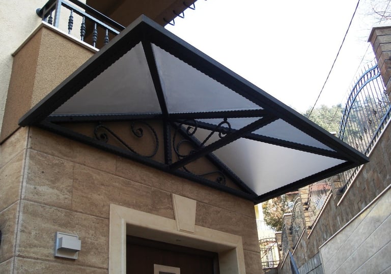 Modern floating wood staircase with ornate wrought iron railing and intricate floral scrollwork.