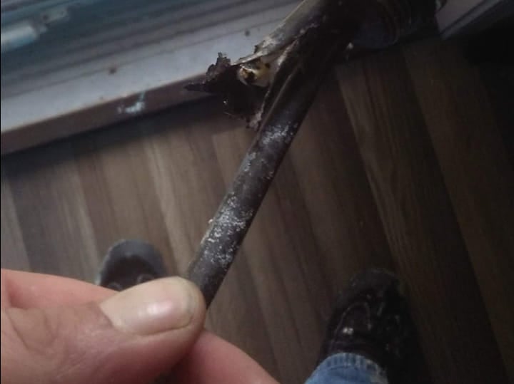 a person holding a small piece of metal in their hand