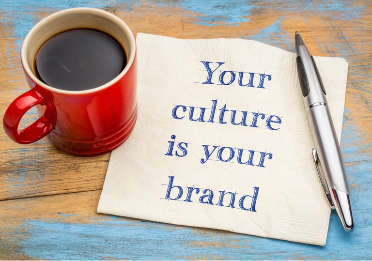 a cup of coffee with a pen and a pen on a napkin