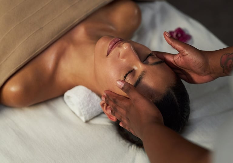 A woman receiving a relaxing facial massage at a luxury wellness spa for skin rejuvenation.
