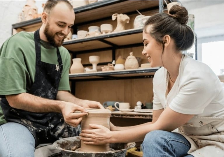 date night pottery fun, a couple making pottery