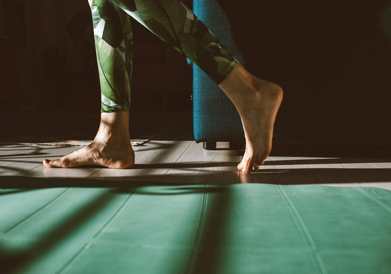 a person standing on a mat with their feet on a mat