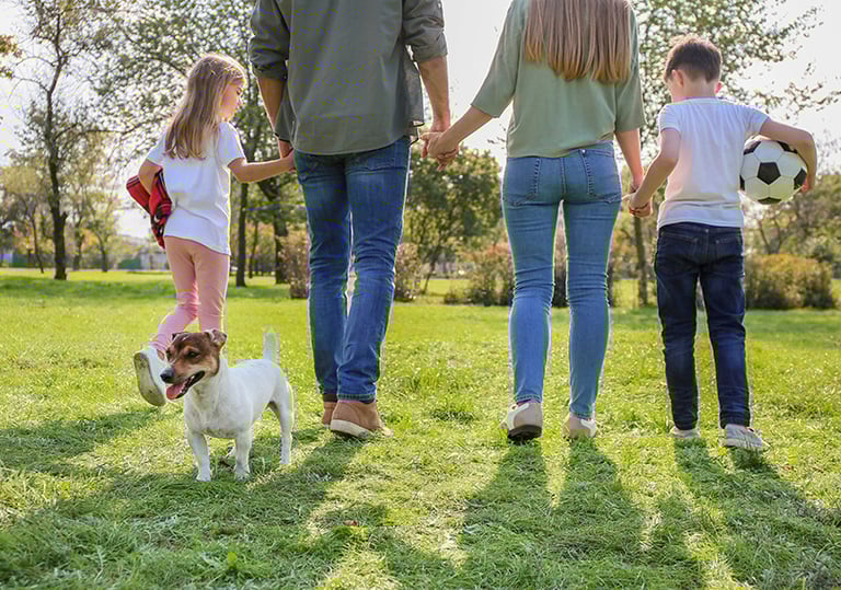 a family of three children playing soccer in a field