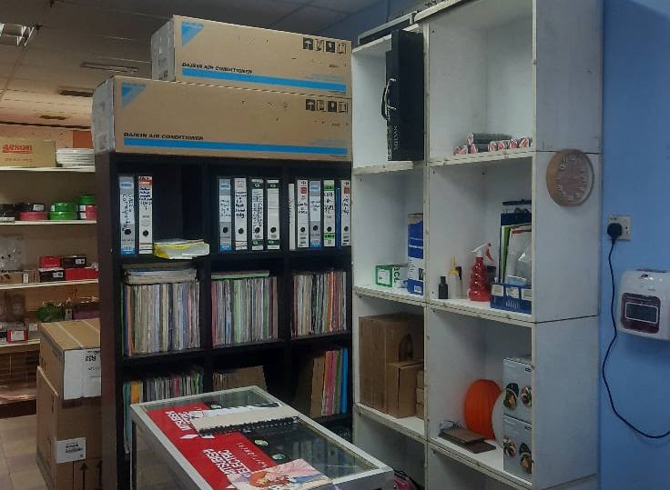 Suasana Aircond professional office, service counter, and Daikin parts stock.