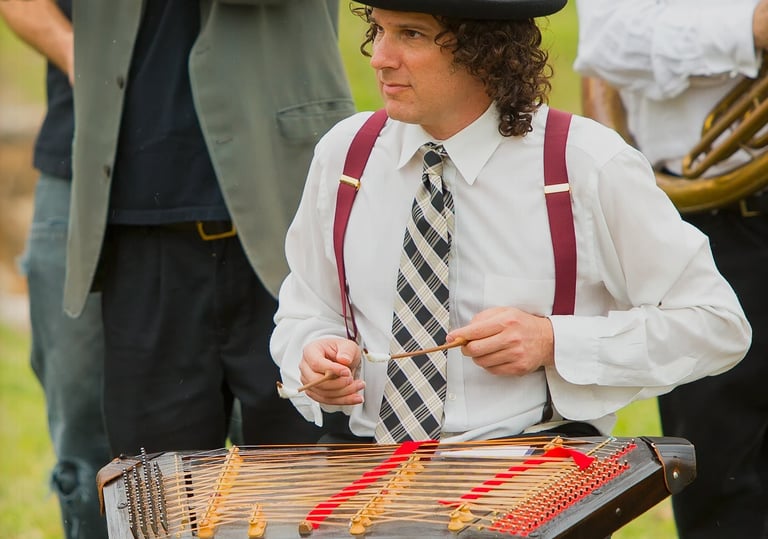 David Ansel playing tsimbl during a Mazel Tov Kocktail Hour show