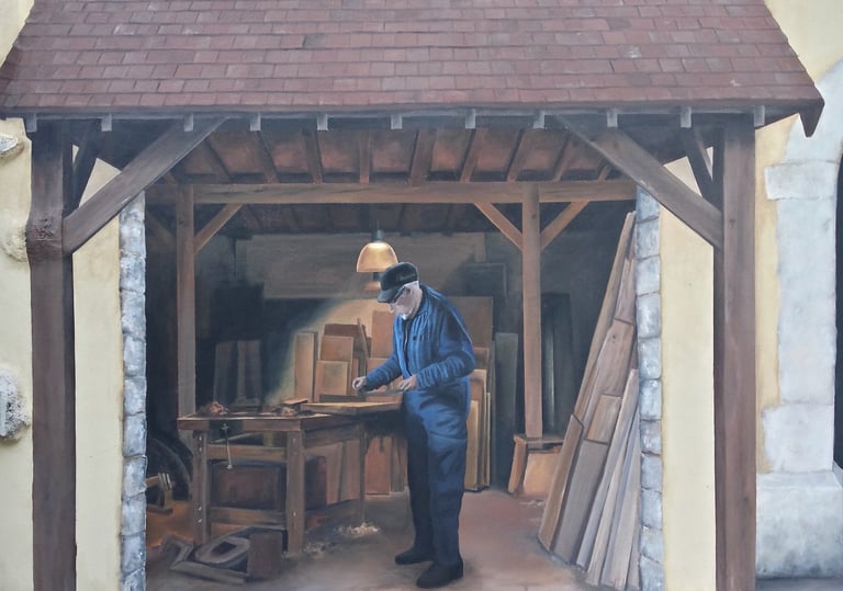 Détail fresque sur façade à Moirans-en-Montagne: un menuisier travaille dans son atelier.