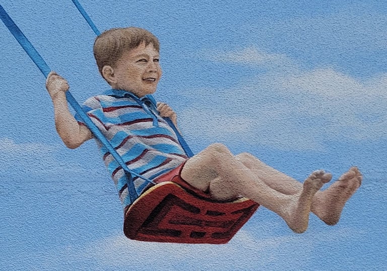 Détail d'une fresque murale: un garçon joue sur une balançoire. Viry, Jura (39).