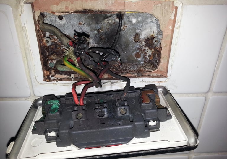 Electrical fault finding revealing heat damage and failed connections within a kitchen socket outlet