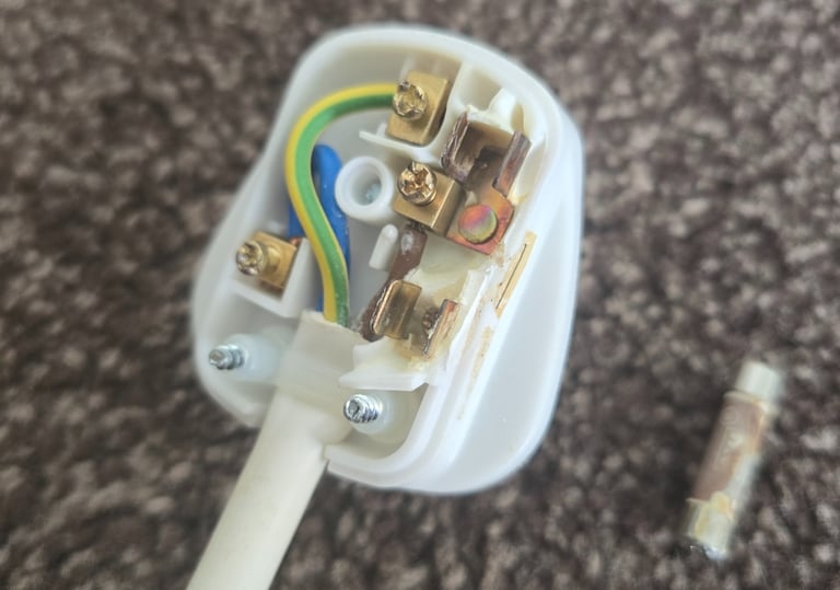 Electrical fault finding revealing overheating damage inside a 13 amp plug caused by a loose connection