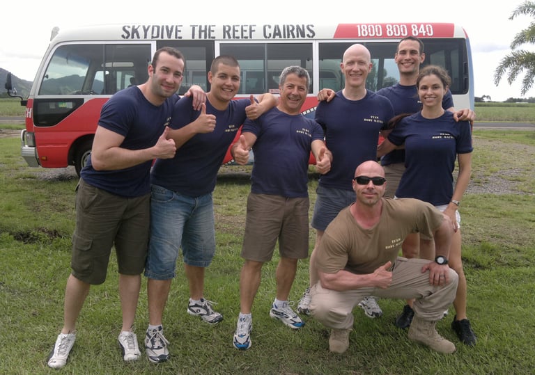 a group of adventure seekers standing in front of a bus