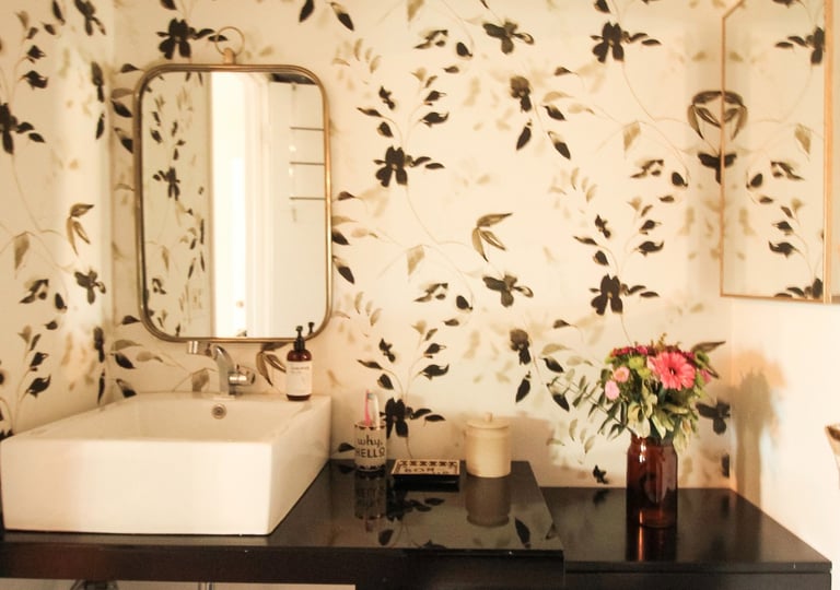 bathroom remodel with floral wallpaper and modern sink basin
