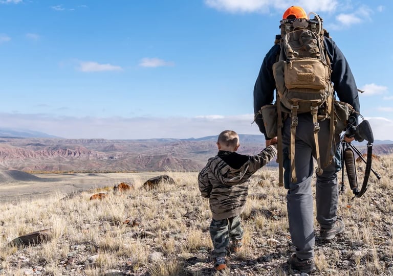 father and son walking to go hunting
