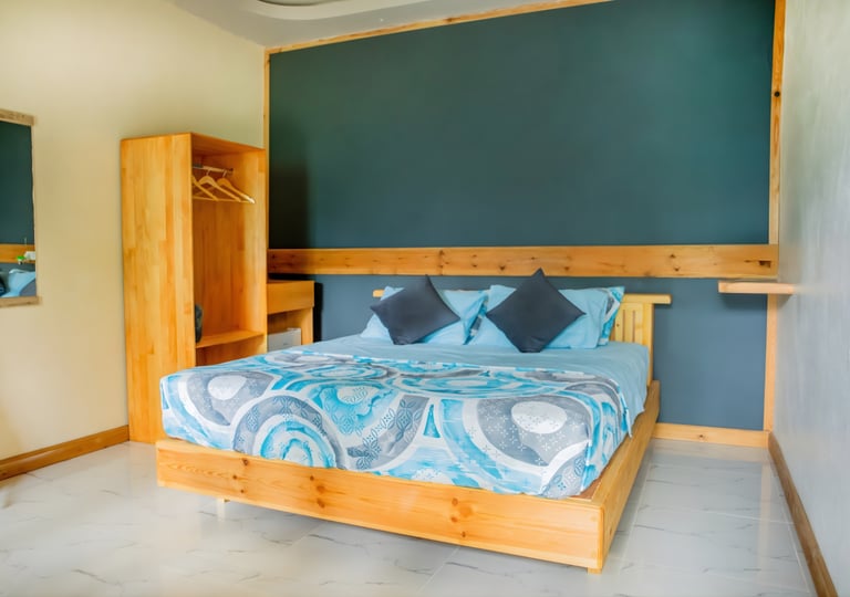 a bed with a blue bedding and a wooden bed