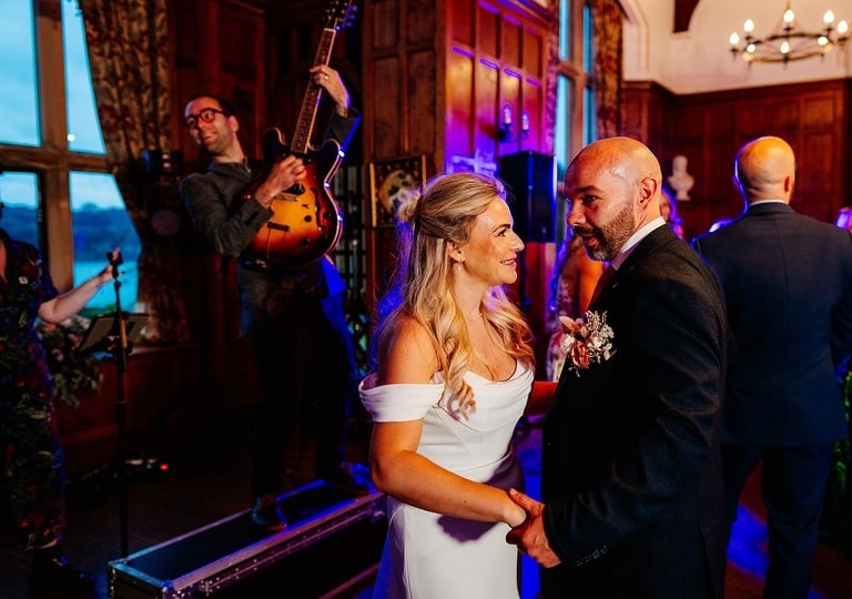 Bride and Groom having first dance with wedding singer musicians