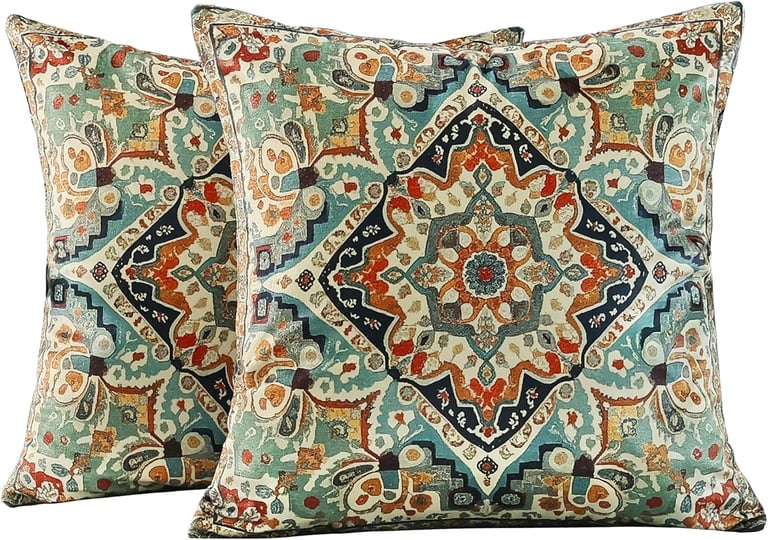 Set of two decorative throw pillows with a vintage medallion tapestry pattern in teal and orange.