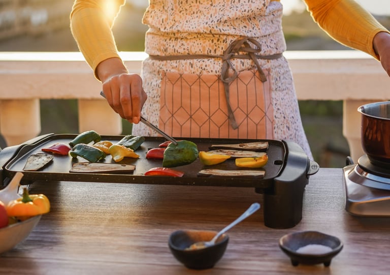 a woman in a white apron is cooking on a grill