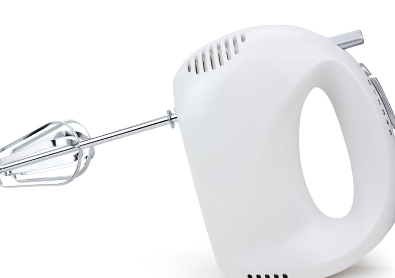 a white hand held mixer with a hand held mixer