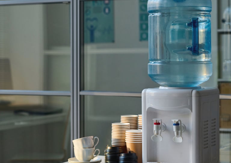 a water bottle with a water dispenser on top of a table