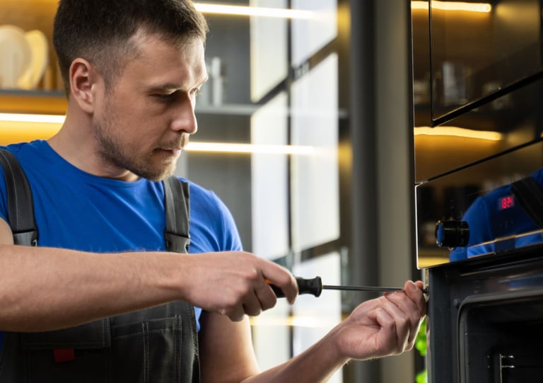 a man in a blue shirt is holding a knife and a knife in his hand