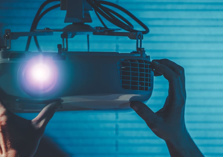 a person holding a projector with a projector light