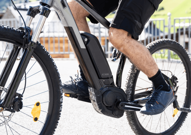 a man riding a bike with a bicycle in the background