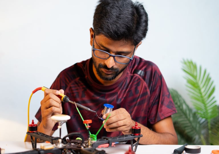 a man is sitting at a table with a small toy