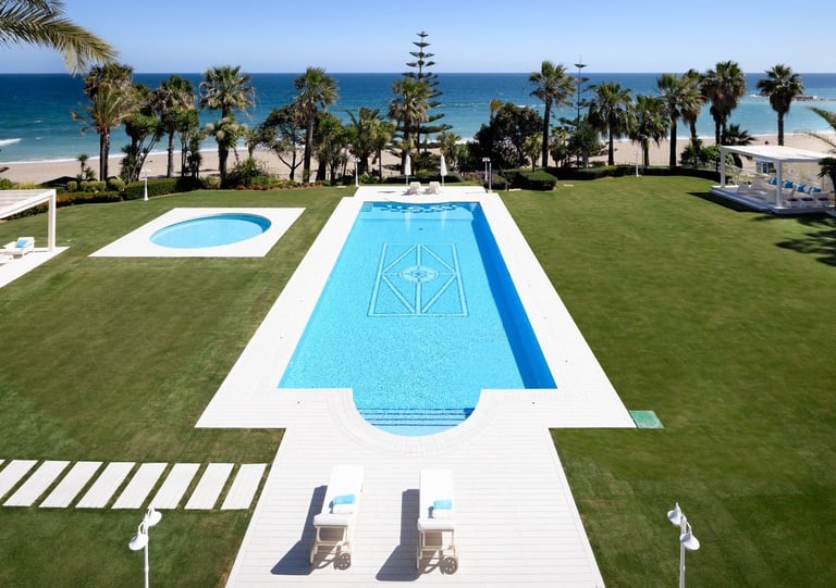 Beachfront pool and gardens at Marbella villa
