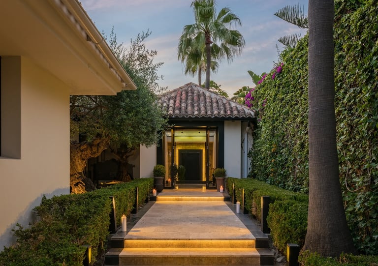 Illuminated villa entrance with stone steps