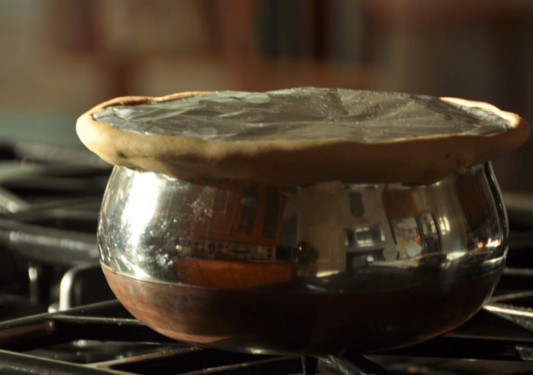 a potted potted with a saucer on top of a stove