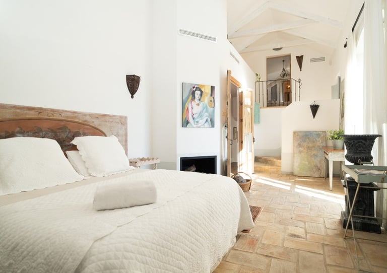 Charming rustic bedroom with art pieces at Finca Santa Katerina