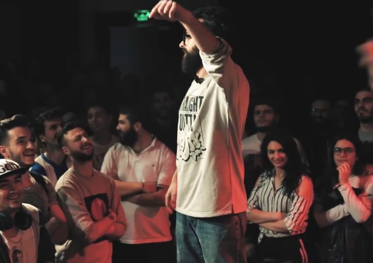 a man standing on a stage in a rap battle in the middle east
