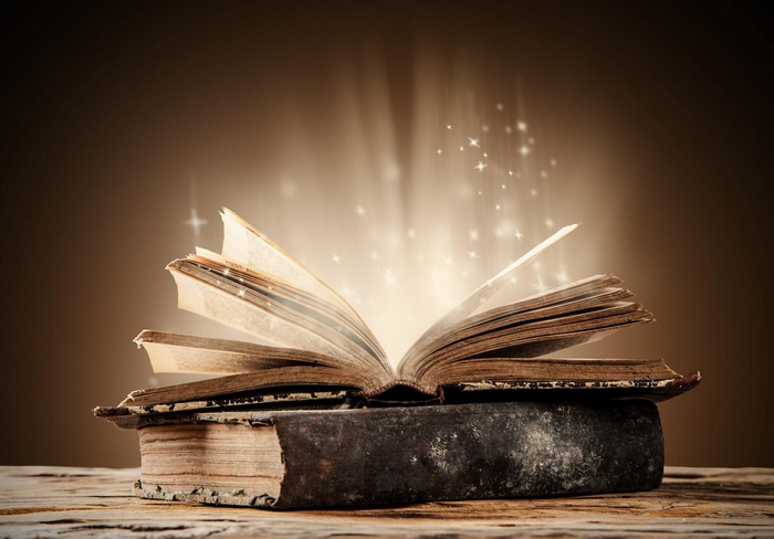 Open book, glowing with stars