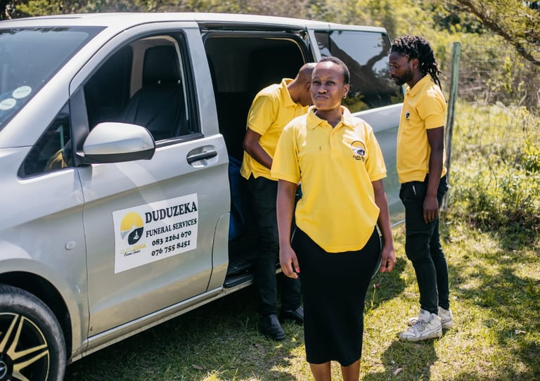 Duduzeka Funeral Services staff in yellow uniforms by their professional transport van.