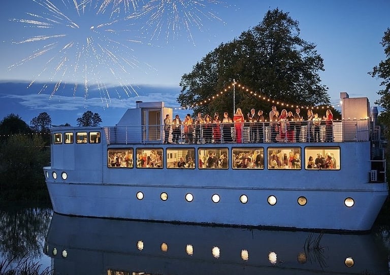 people are celebrating onboard the ark northampton at nighttime with fireworks