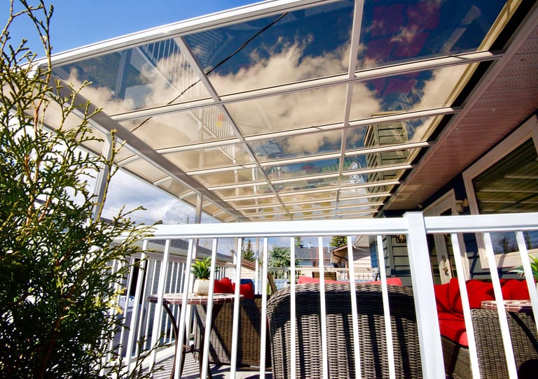 Patio Cover over a deck with tinted see-through panels.