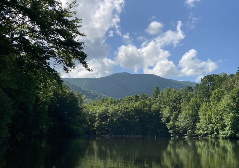 Mountain is solid overlooking lake in nature setting