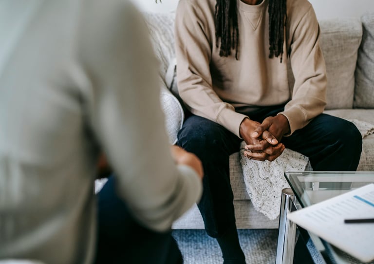 a man and woman sitting on a couch