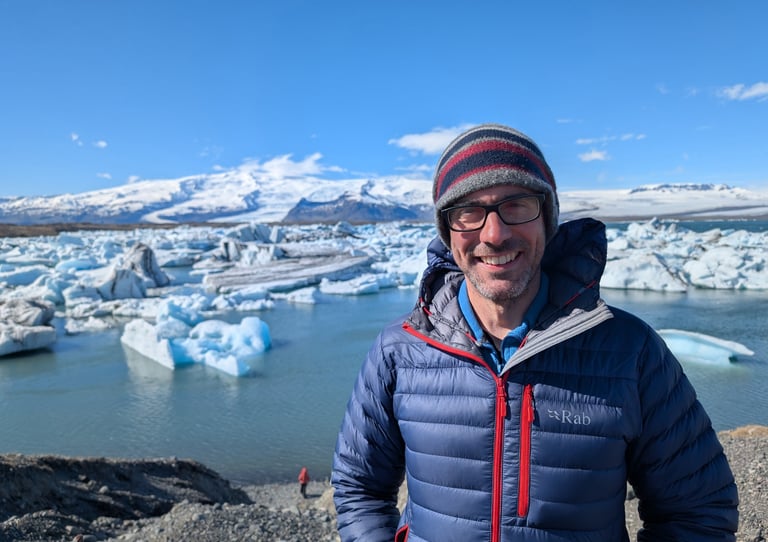 a man in a blue jacket and a hat