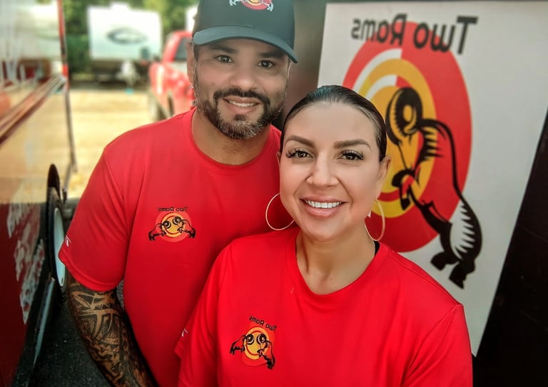 a man and woman standing in front of a two - story building