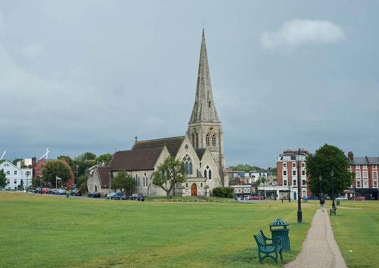 A scenic view of the historic St Mary's Church with its tall spire overlooking Blackheath Common in London.