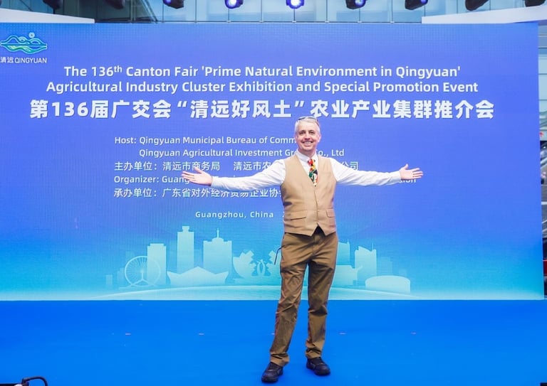 a man standing in front of a banner that says, the man is holding a