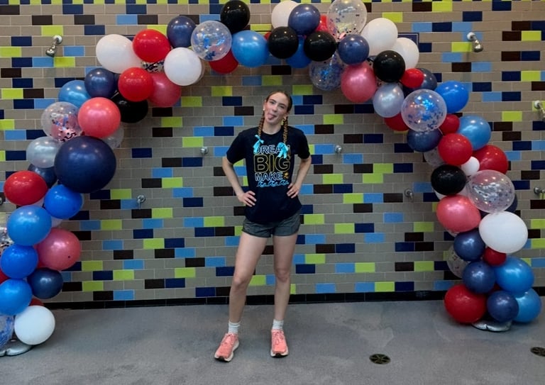 a woman standing in front of a balloon - shaped balloon