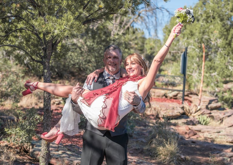 a man and woman are holding a flower