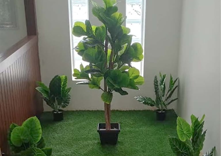 Low-maintenance artificial plants styled to look natural by Garden Designers