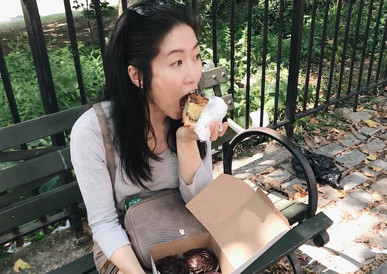 little twist bakery founder eating on a bench in NYC