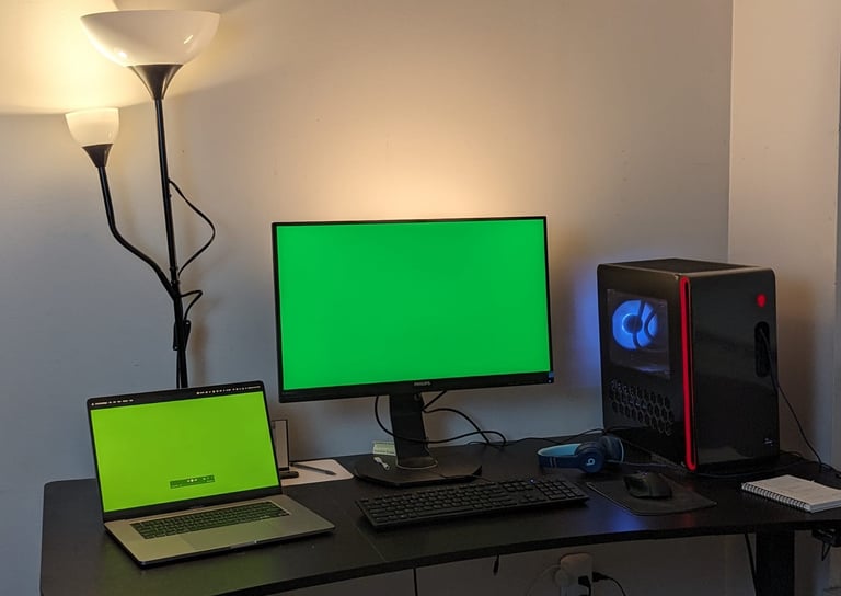 a desk with a laptop and a computer monitor