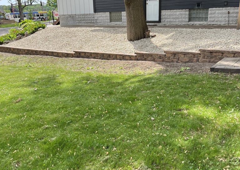 rock landscaping alongside residential driveway in central mn