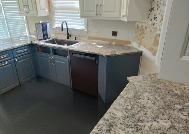 Modern kitchen with blue cabinets and multicolor granite countertops
