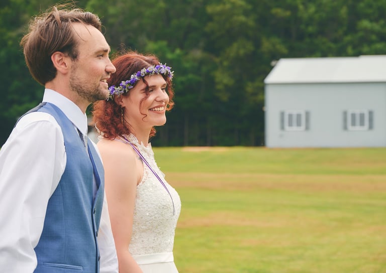 a man and woman walking in a farm land