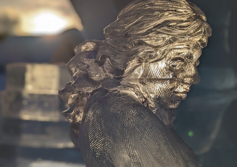 ice sculpture of a delicate feminine figure with dramatic late day lighting